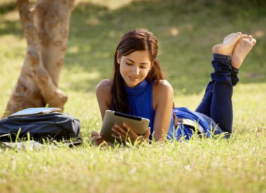 Woman with books and ipad studying for college test Woman with books and ipad studying for college test